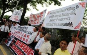 Protesters campaign in front of the British High Commission in Kuala Lumpur to condemn the historic Batang Kali massacre